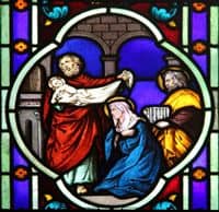 Stained Glass Window depiction of Mary and Joseph's presentation of Jesus in the Temple.