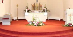 Inside a Catholic Church showing Altar in preparation for Holy Mass.
