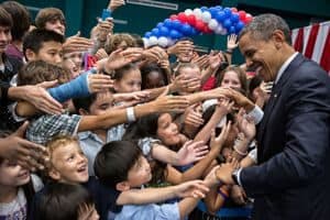Barack Obama shaking hands with children