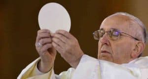 Pope Francis holding the Sacred Host aloft
