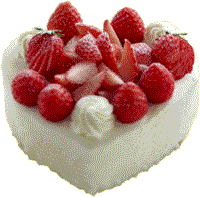 Heart-shaped cake with strawberries and cream on top.