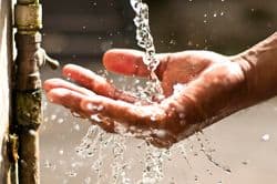 Water from tap falling on hand