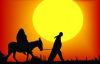 Small silhouette of man riding donkey