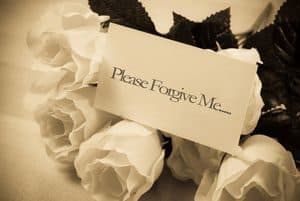 Flowers with note saying, "Please forgive me"