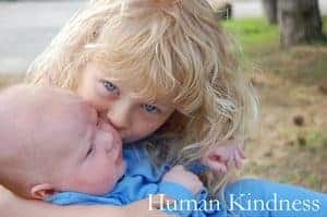 Young girl hugging baby