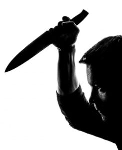 Silhouette of man holding a knife