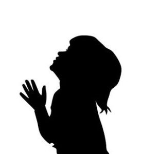 Silhouette of praying child
