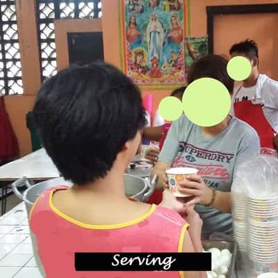 Volunteers serving a meal.