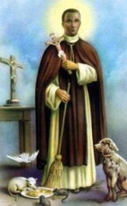 St Martin de Porres holding a Cross and surrounded by animals.