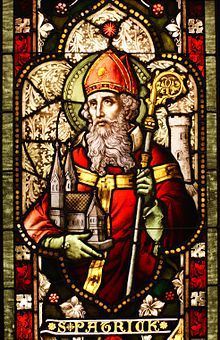 Stain-glass image of St Patrick holding a Bishop's Staff.